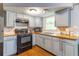 Efficient kitchen with wood-look flooring, stainless steel sink, and modern appliances at 9020 Gray Fox Ln, Port Richey, FL 34668