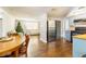 The open-concept kitchen features stainless steel appliances, wood cabinets, and modern fixtures at 9020 Gray Fox Ln, Port Richey, FL 34668