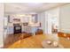 Well-equipped kitchen featuring updated appliances, light countertops, and neutral backsplash at 9020 Gray Fox Ln, Port Richey, FL 34668