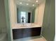 Bright bathroom featuring a double sink vanity with dark cabinets and a large mirror at 100 1St N Ave # 702, St Petersburg, FL 33701