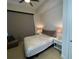 Cozy bedroom features a ceiling fan, neutral walls, and two bedside tables with lamps at 100 1St N Ave # 702, St Petersburg, FL 33701