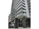 Upscale high-rise building featuring large windows and glass-railed balconies for each unit at 100 1St N Ave # 702, St Petersburg, FL 33701