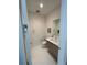 Tastefully designed half bathroom with a modern vanity and stylish mirror at 100 1St N Ave # 702, St Petersburg, FL 33701