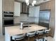 Stylish kitchen with stainless steel appliances, a center island with seating, and modern lighting fixtures at 100 1St N Ave # 702, St Petersburg, FL 33701