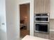 Modern kitchen featuring stainless steel appliances, light wood cabinets, and a view into the bedroom at 100 1St N Ave # 702, St Petersburg, FL 33701