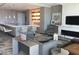 Stylish living room with modern fireplace, display shelving, and a sleek bar area at 100 1St N Ave # 702, St Petersburg, FL 33701