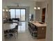 Open-concept living space boasts a full kitchen, dining area, and floor-to-ceiling windows with marina views at 100 1St N Ave # 702, St Petersburg, FL 33701