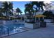 Inviting outdoor pool area with yellow umbrellas and palm trees, perfect for relaxation at 100 1St N Ave # 702, St Petersburg, FL 33701