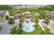 Stunning aerial view of the community center and splash pad with surrounding homes and lush greenery at 1022 Montgomery Bell Rd, Wesley Chapel, FL 33543