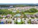 Stunning aerial view of the community pool and clubhouse surrounded by lush landscaping and beautiful homes at 1022 Montgomery Bell Rd, Wesley Chapel, FL 33543