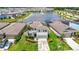 Aerial view of a beautiful house overlooking a tranquil lake with a fountain at 1022 Montgomery Bell Rd, Wesley Chapel, FL 33543