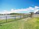 Expansive backyard with lawn, fence, and a scenic lake view at 1022 Montgomery Bell Rd, Wesley Chapel, FL 33543
