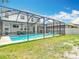 Backyard view of home featuring covered pool and patio area with outdoor seating at 1022 Montgomery Bell Rd, Wesley Chapel, FL 33543