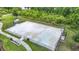 Community basketball court surrounded by black fencing with walkway access at 1022 Montgomery Bell Rd, Wesley Chapel, FL 33543