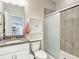 Bathroom features vanity with granite countertops and cabinet, plus glass-enclosed tiled shower at 1022 Montgomery Bell Rd, Wesley Chapel, FL 33543