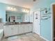 Spacious bathroom features double vanity with granite counters, tile floors, and coastal-themed decorations at 1022 Montgomery Bell Rd, Wesley Chapel, FL 33543