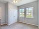 Bedroom with standard closet and two windows to backyard at 1022 Montgomery Bell Rd, Wesley Chapel, FL 33543