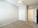 Comfortable carpeted bedroom with a ceiling fan, closet, and an entryway to a bathroom or closet at 1022 Montgomery Bell Rd, Wesley Chapel, FL 33543