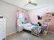 Inviting bedroom with butterfly decor, bright natural light, and a view to the outdoors at 1022 Montgomery Bell Rd, Wesley Chapel, FL 33543