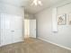 Carpeted bedroom with a ceiling fan, closet, and a minimalist aesthetic for a modern feel at 1022 Montgomery Bell Rd, Wesley Chapel, FL 33543