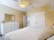 Well-lit bedroom with a ceiling fan, white dresser, closet, and neutral tones for a relaxing ambiance at 1022 Montgomery Bell Rd, Wesley Chapel, FL 33543