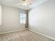 Neutral bedroom featuring a ceiling fan, plush carpeting, and a bright window for natural light at 1022 Montgomery Bell Rd, Wesley Chapel, FL 33543
