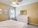 Charming bedroom with a window view, white dresser, and framed artwork creating a serene space at 1022 Montgomery Bell Rd, Wesley Chapel, FL 33543