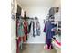 Walk-in closet with clothes, shoes, and storage containers at 1022 Montgomery Bell Rd, Wesley Chapel, FL 33543