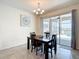 Cozy dining room with stylish chandelier, dark wood table, and sliding glass doors to the outdoors at 1022 Montgomery Bell Rd, Wesley Chapel, FL 33543