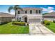 Beautiful two-story home with a well-manicured lawn and a two-car garage at 1022 Montgomery Bell Rd, Wesley Chapel, FL 33543