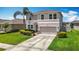 Charming two-story home with lush landscaping, a well-manicured lawn, and a spacious driveway at 1022 Montgomery Bell Rd, Wesley Chapel, FL 33543