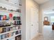 Bright hallway with built-in shelving and view to a bedroom featuring a dresser and natural light at 1022 Montgomery Bell Rd, Wesley Chapel, FL 33543