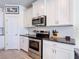 Well-equipped kitchen with stainless steel appliances, granite countertops, and white cabinetry at 1022 Montgomery Bell Rd, Wesley Chapel, FL 33543