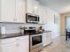 Kitchen featuring stainless steel appliances, white subway tile backsplash, and granite countertops at 1022 Montgomery Bell Rd, Wesley Chapel, FL 33543