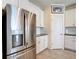 The kitchen features stainless steel appliances, white cabinets, granite countertops, and tile floors at 1022 Montgomery Bell Rd, Wesley Chapel, FL 33543