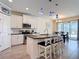 Bright kitchen with white cabinets, granite counters, stainless appliances, and a center island with seating at 1022 Montgomery Bell Rd, Wesley Chapel, FL 33543