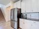 The kitchen offers stainless steel appliances, white cabinets, granite countertops, and subway tile backsplash at 1022 Montgomery Bell Rd, Wesley Chapel, FL 33543