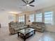 Inviting living room has tile floors, neutral colors, a ceiling fan, and lots of natural light at 1022 Montgomery Bell Rd, Wesley Chapel, FL 33543
