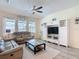 Comfortable living room with ample natural light, a ceiling fan, and a built-in entertainment center at 1022 Montgomery Bell Rd, Wesley Chapel, FL 33543