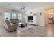Comfortable living room with tile floors, ceiling fan, and entertainment center at 1022 Montgomery Bell Rd, Wesley Chapel, FL 33543