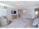Upstairs living area with comfortable seating, neutral carpet, and mounted TV with views of backyard at 1022 Montgomery Bell Rd, Wesley Chapel, FL 33543