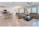 Open concept living room featuring neutral decor, tile floors, and access to the kitchen and dining area at 1022 Montgomery Bell Rd, Wesley Chapel, FL 33543