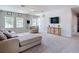 The upstairs living room is neutrally decorated, with plenty of natural light from the large windows at 1022 Montgomery Bell Rd, Wesley Chapel, FL 33543