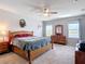 Bright main bedroom featuring a ceiling fan and wooden dresser at 1022 Montgomery Bell Rd, Wesley Chapel, FL 33543
