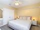 Comfortable main bedroom features a bed with white linens and pink accents at 1022 Montgomery Bell Rd, Wesley Chapel, FL 33543
