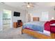 Bright main bedroom leading to bathroom with dark wood dresser at 1022 Montgomery Bell Rd, Wesley Chapel, FL 33543