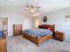 Bright main bedroom featuring a ceiling fan and dark wooden dresser at 1022 Montgomery Bell Rd, Wesley Chapel, FL 33543