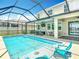 Relaxing screened-in pool with lounge chairs, ceiling fan, and space for outdoor entertaining at 1022 Montgomery Bell Rd, Wesley Chapel, FL 33543