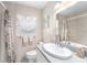 Well-lit bathroom with tiled walls, a decorative shower curtain, and large mirror at 10400 112Th Way, Largo, FL 33778