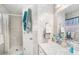 Clean, tiled bathroom featuring a shower, vanity, and well-lit mirror at 10400 112Th Way, Largo, FL 33778